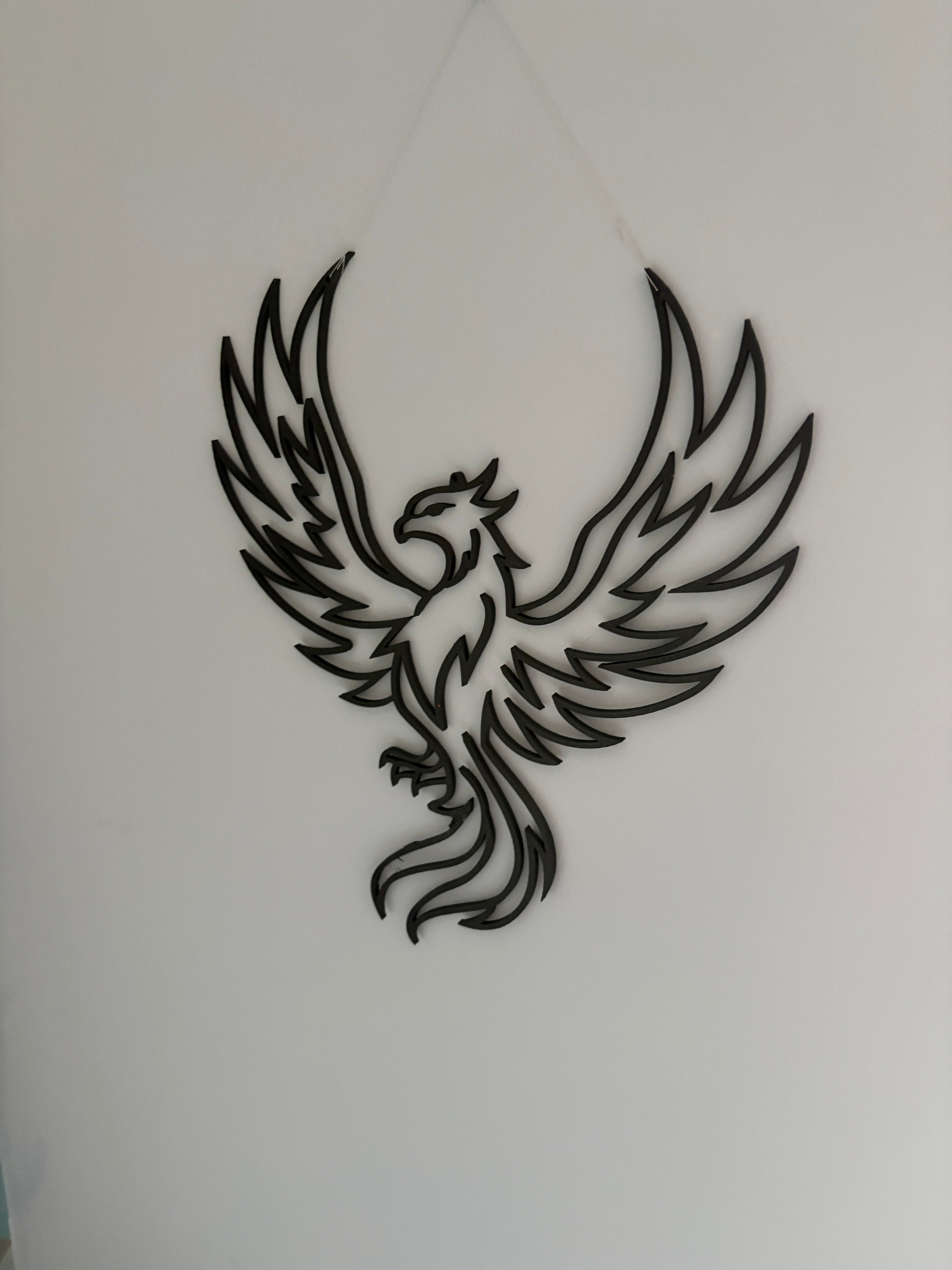 3D printed phoenix wall decoration, in a modern, clean style.